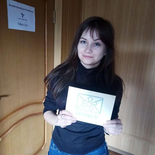 A recipient at her door with a delivered envelope.