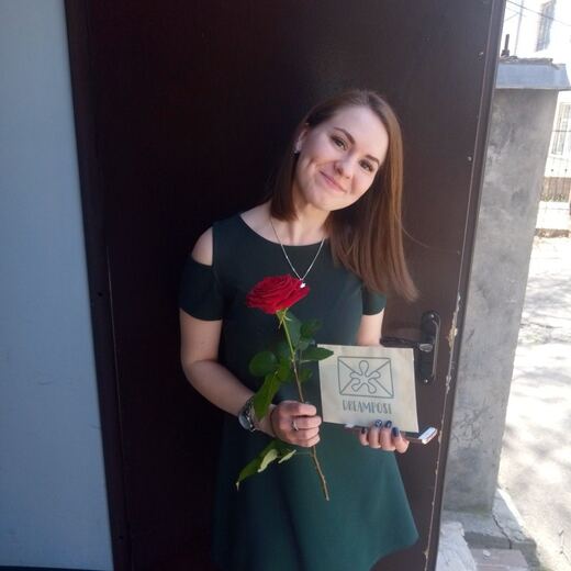 A recipient holding a delivered envelope at home.