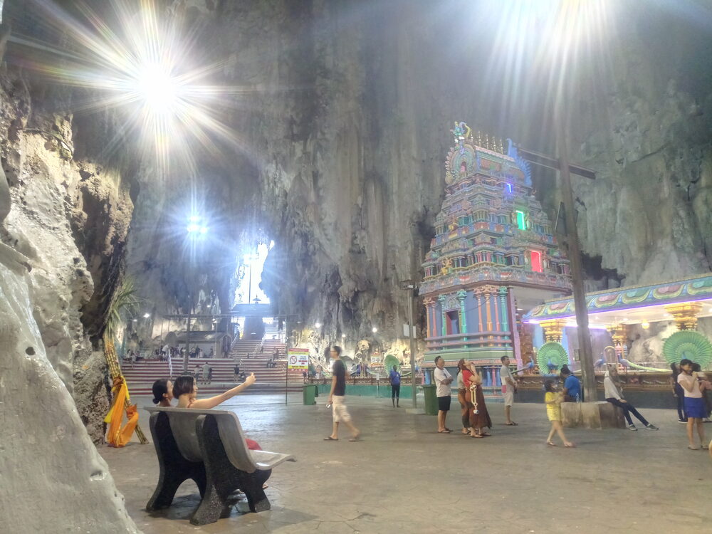 The Batu Caves temple complex near Kuala Lumpur, Malaysia, lit by shafts of daylight.